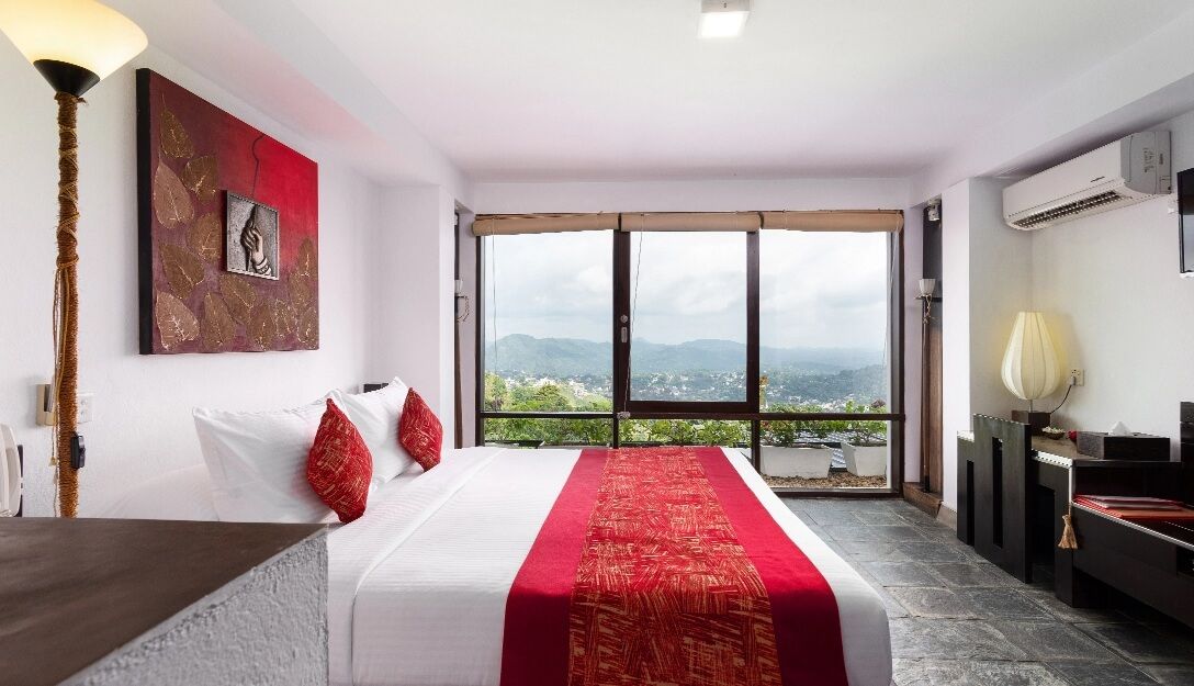Elegant deluxe room with mountain views at Theva Residency Kandy