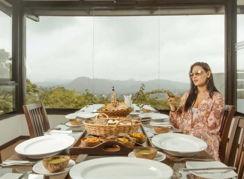 A girl enjoying a Sri Lankan breakfast at Theva Residency
