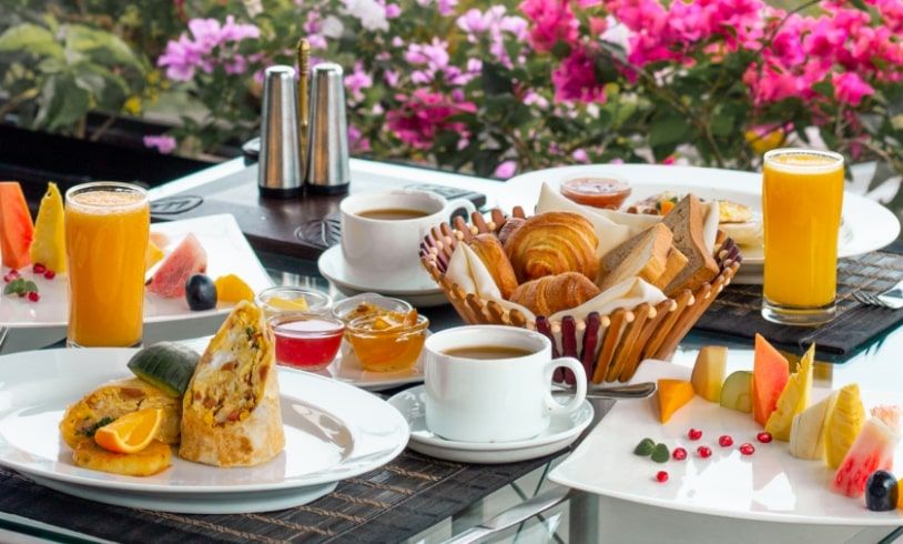 Breakfast with vibrant floral views at Theva Residency Kandy restaurants